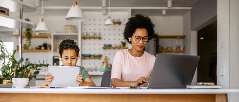 mother and son using laptop and tablet